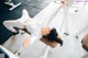 A woman laying on a bench in a gym.