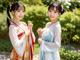 A couple of women dressed in traditional chinese clothing posing for a picture.