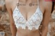 A woman wearing a white bra and panties. 