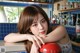 A woman leaning on a counter in a bar.